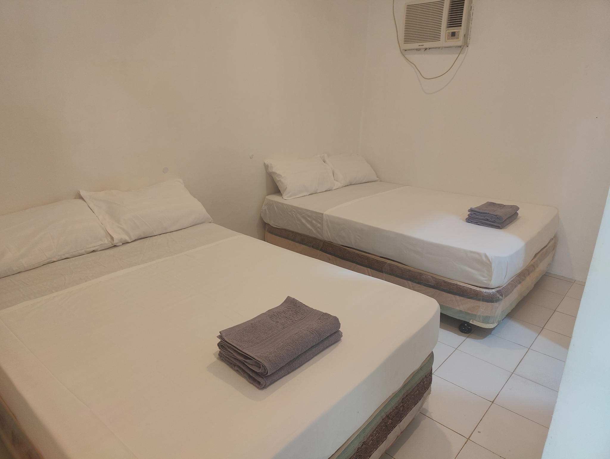 Room with two beds and fresh towels